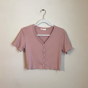 Pink cropped short sleeve top with v-neck and white buttons